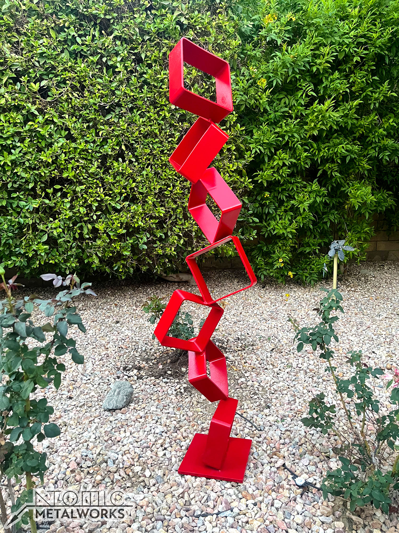 Intervals metal sculpture made from stacked hollow steel squares, painted bright red.